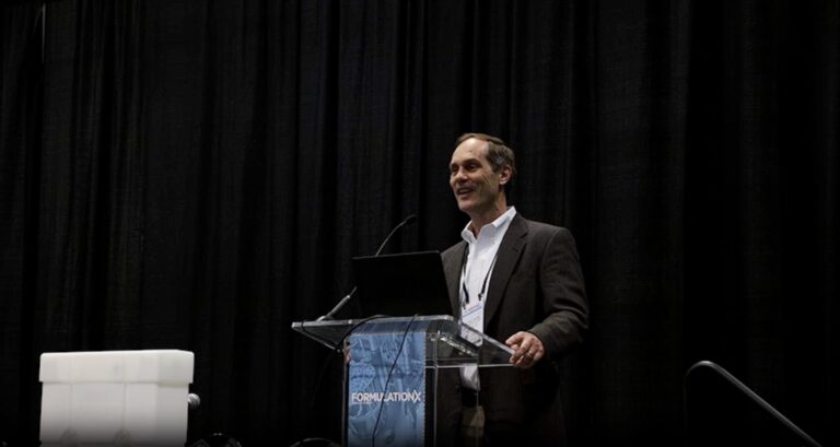 Jeff Johnson speaking at podium during a conference.