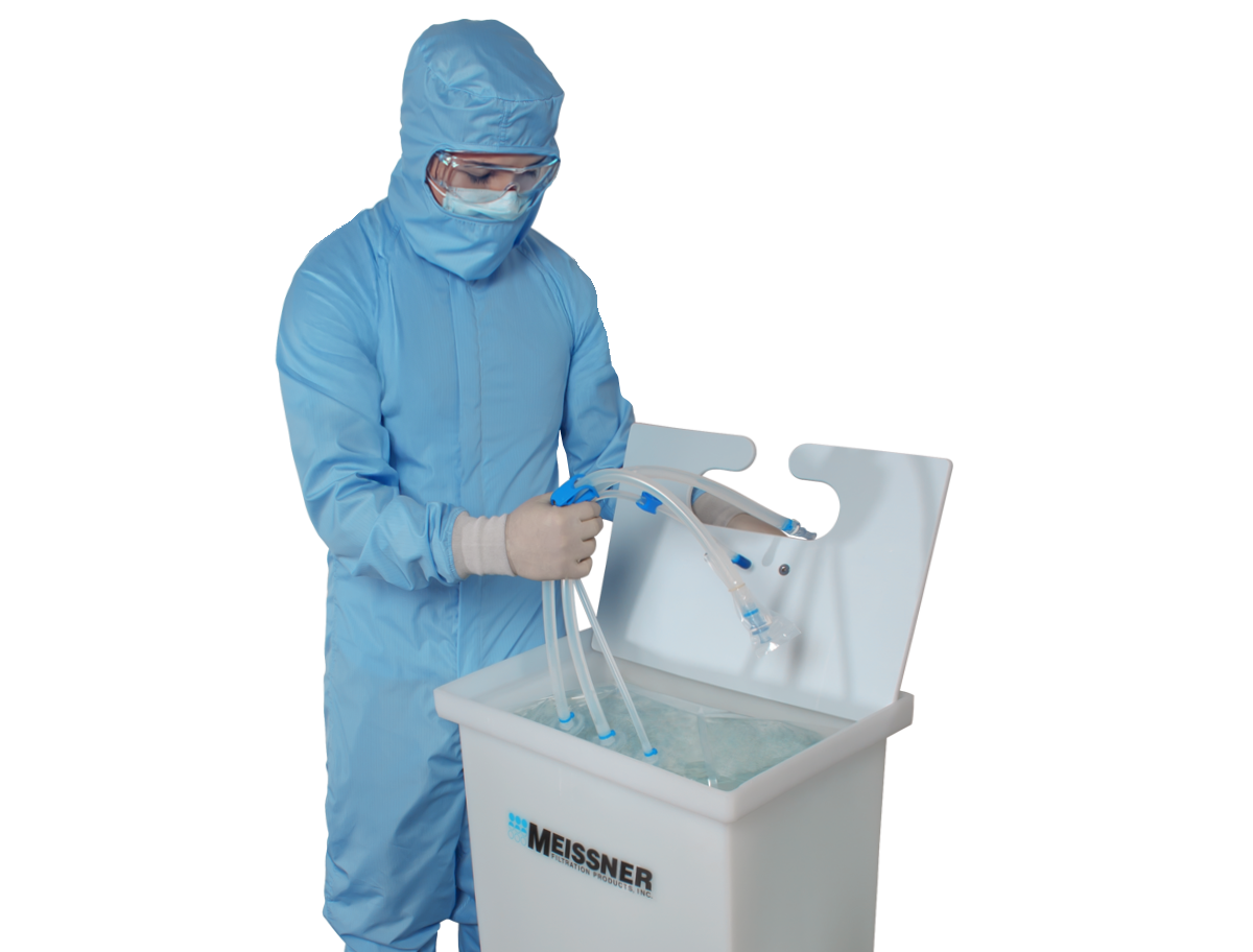 Person in cleanroom suit handling filtration equipment.